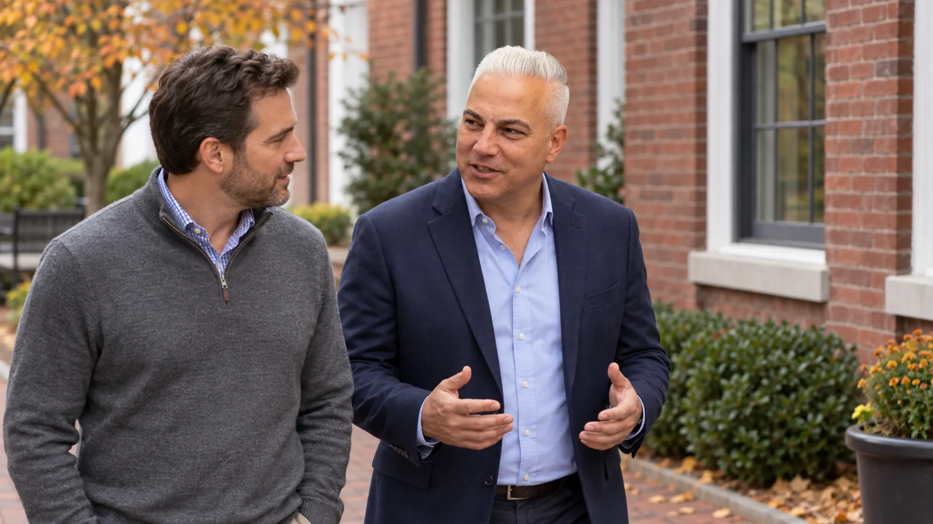 Dan Balkun discussing closing-provider questions with a buyer in a brick courtyard