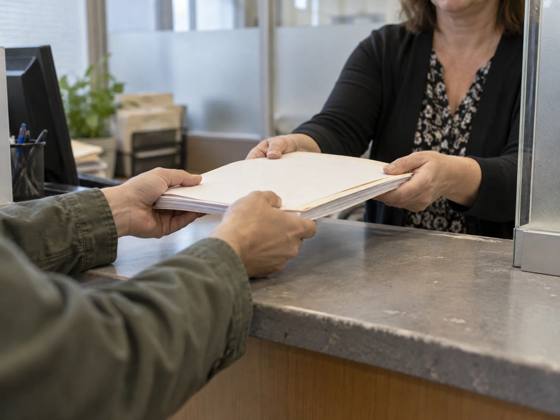 A document packet being submitted at a municipal recording counter